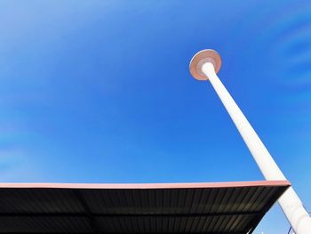 Low angle view of street light against building against clear sky