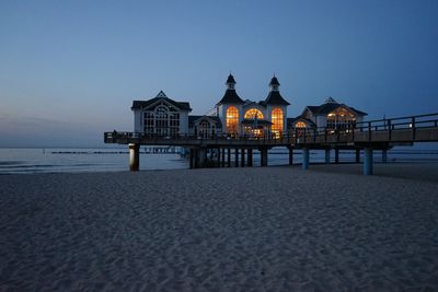 Building at beach against clear sky