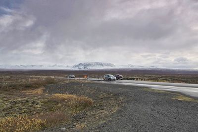 Scenic view of mountains against cloudy sky