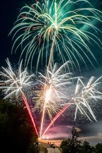 Low angle view of firework display at night