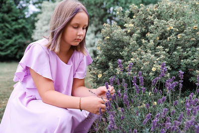 Young woman standing amidst plants