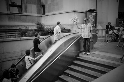 People standing on staircase in city
