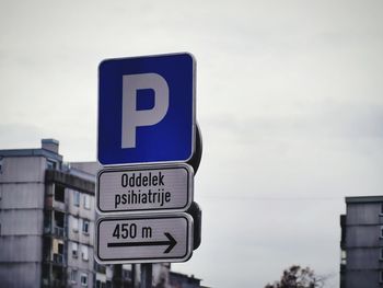 Information sign against sky