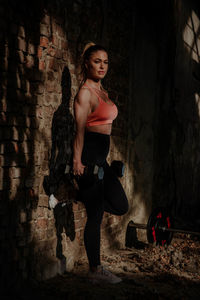 Portrait of woman while standing in abandoned building