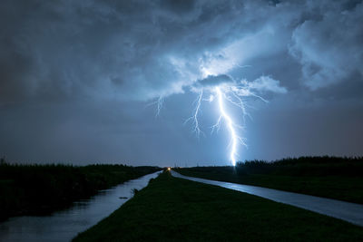 Powerful branched lightning bolt strikes in the countryside of holland