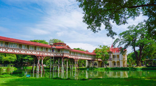 Built structure in park by lake against sky