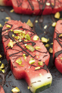 Popsicles or ice cream shaped fresh water melon with pistachios nuts and chocolate decorations