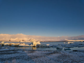 Scenic view of frozen sea against sky during winter