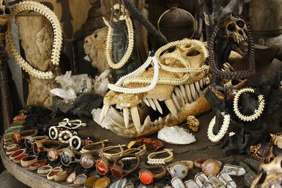 High angle view of old jewelries with animal skeletons on table