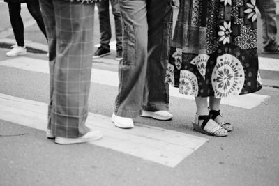 Low section of people walking on street