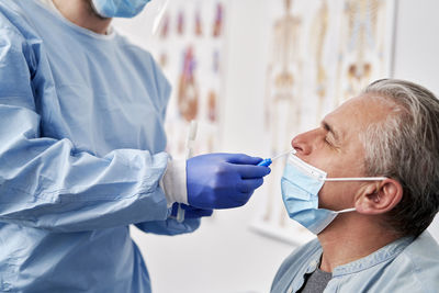 Female dentist examining patient in laboratory