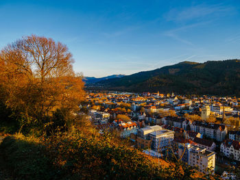 High angle view of town against blue sky