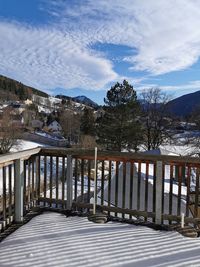 Scenic view of trees by mountains against sky