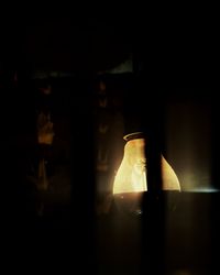 Close-up of illuminated light bulb on table