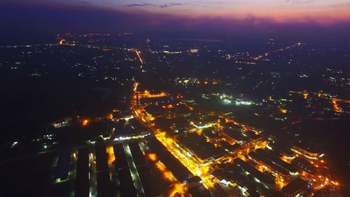 High angle view of illuminated buildings in city at night