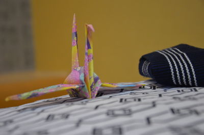 Paper crane on fabric at home