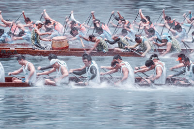 Group of people with boats in sea