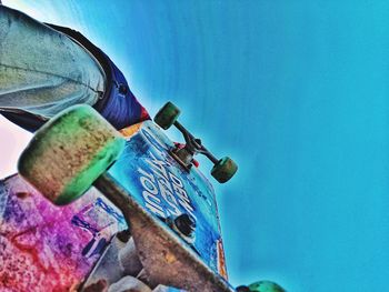 Close-up of rusty metal against blue sky