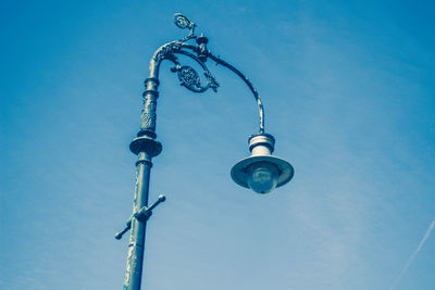 Low angle view of communications tower against clear blue sky