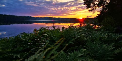 Scenic view of lake against sky at sunset