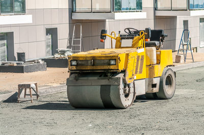 Yellow cart on road in city