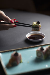 Close-up of hand holding food on table