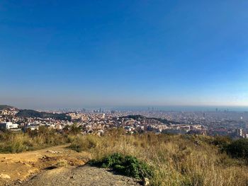 High angle view of cityscape against clear blue sky