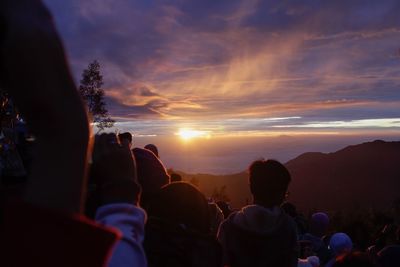 People photographing at sunset