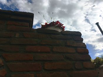 Low angle view of building against cloudy sky