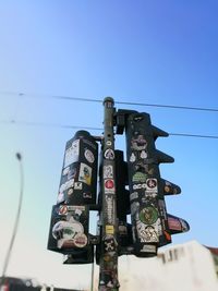 Low angle view of communications tower against blue sky