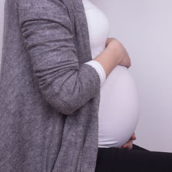 High angle view of pregnant woman standing at home