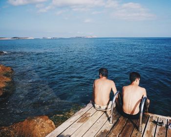 Man sitting on pier