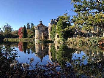 Reflection of building on lake against sky