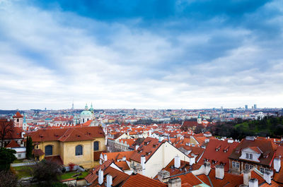 View of cityscape against cloudy sky