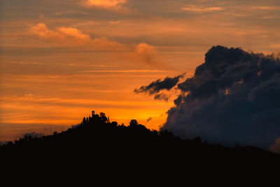 Colorful cloudy sunset over the sanctuary of montevecchia, lombardia, italy