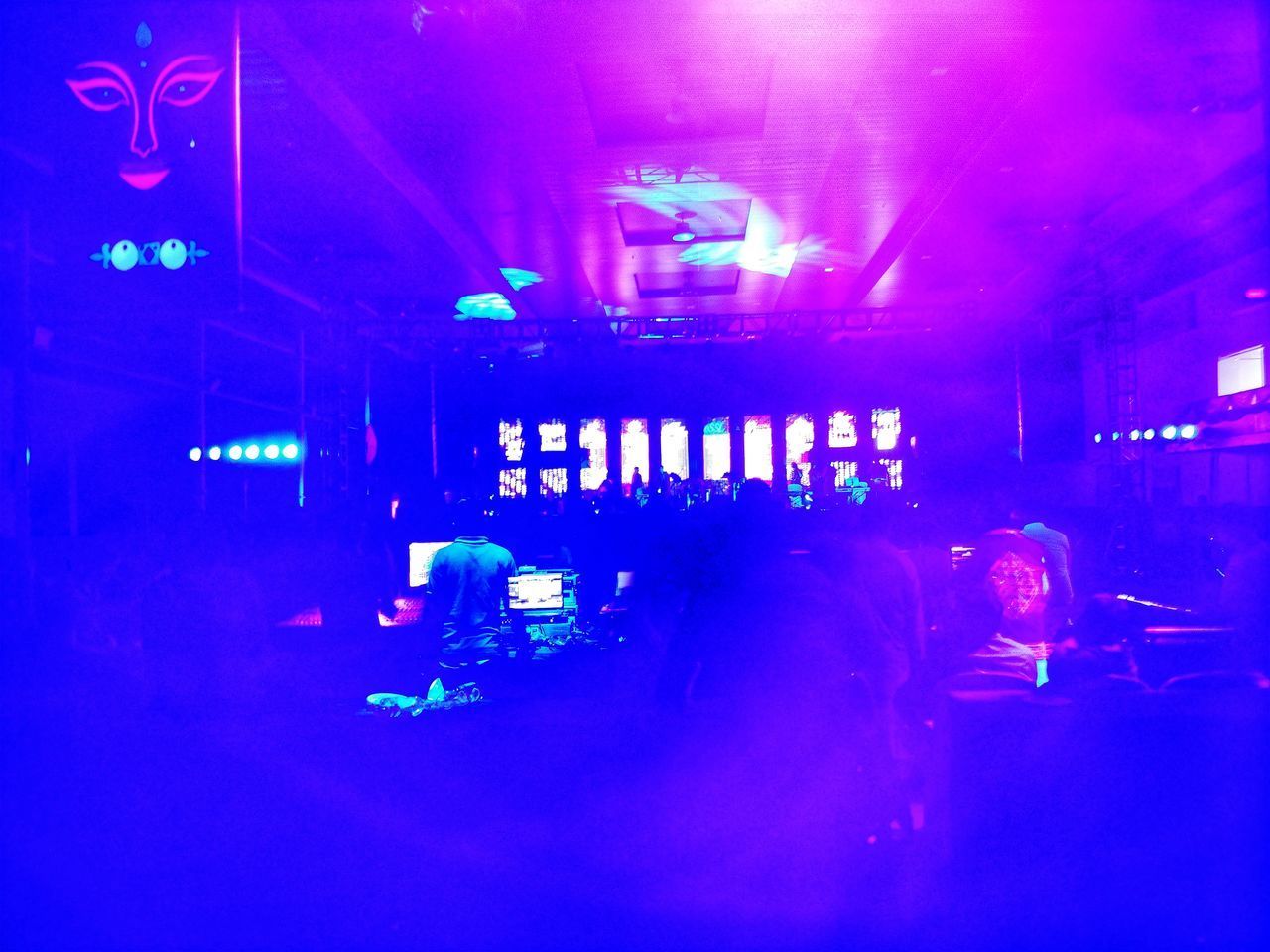 PEOPLE IN ILLUMINATED NIGHTCLUB AT CONCERT