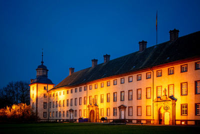 Buildings against blue sky at night