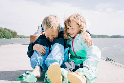 Friends sitting on shore