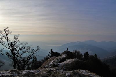 Scenic view of silhouette mountains against sky at sunset