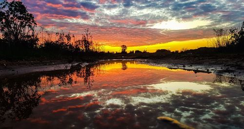 Scenic view of lake against orange sky