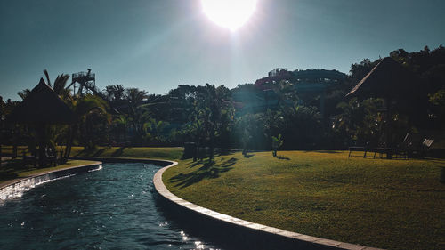 Scenic view of park against sky on sunny day