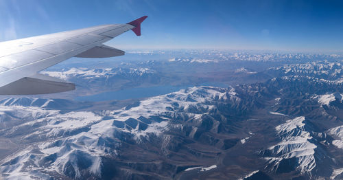 Aerial view of snowcapped mountains during winter