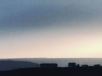 Silhouette buildings against clear sky