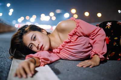 Portrait of woman lying on bed