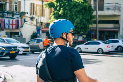 Man standing on street in city