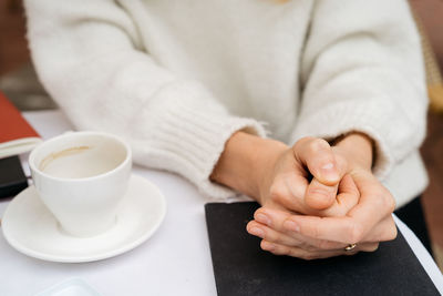 Midsection of coffee cup on table