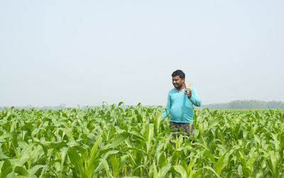 Portrait of man standing in field