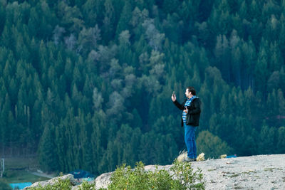 Rear view of man standing on rock