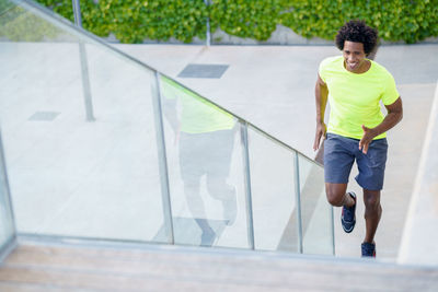 Full length of man running on railing