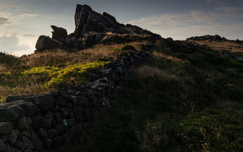 Rock formations on landscape against sky